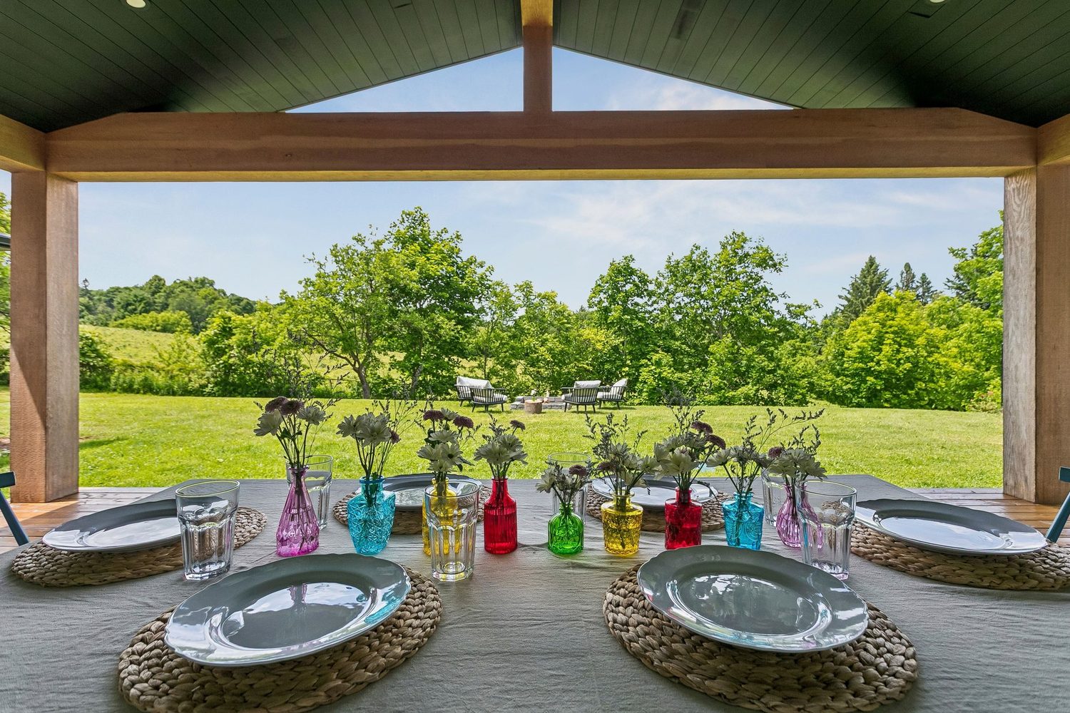 Covered porch and deck overlooking open farmland
