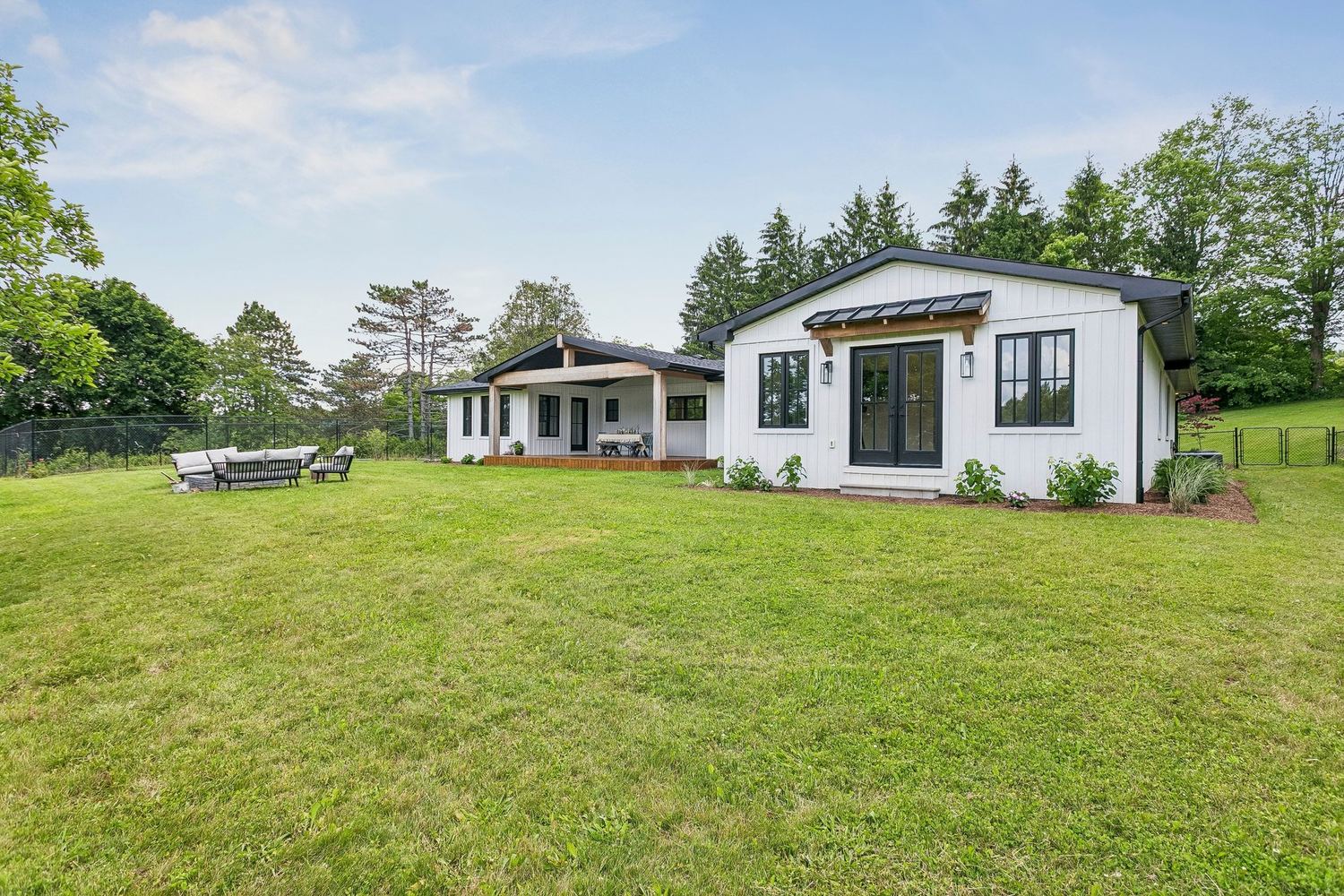 The home nestled within its treed acre