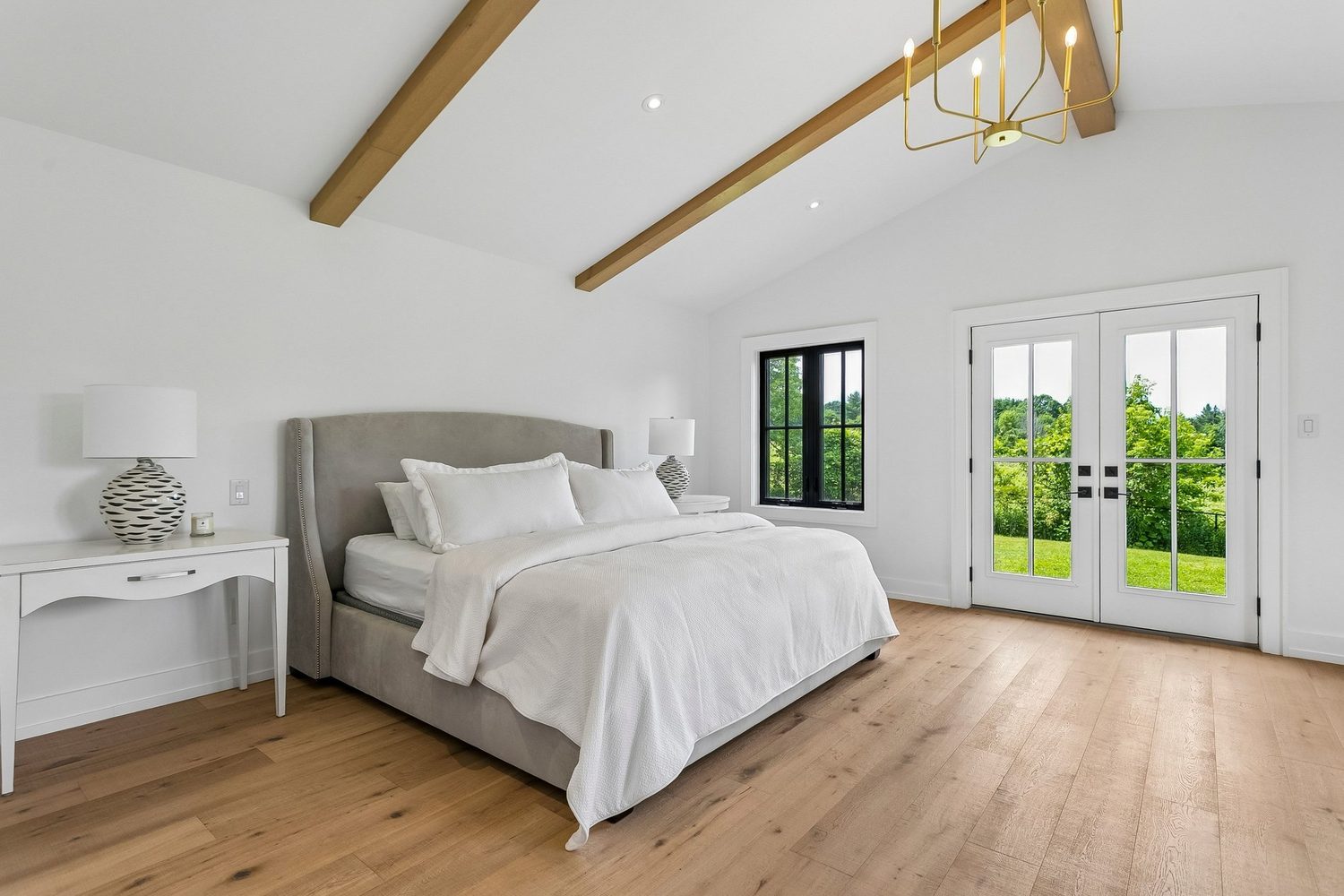 Primary suite with cathedral ceiling, beams and walkout